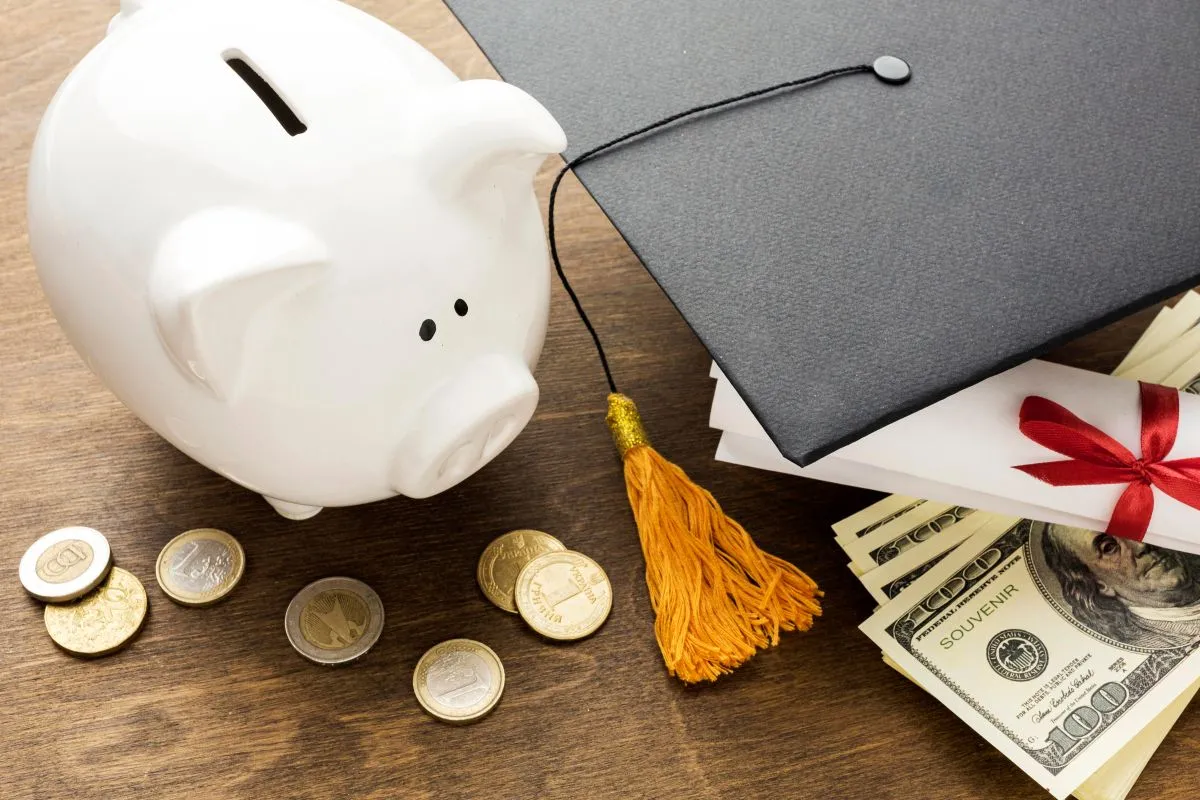 Graduation cap beside a piggy bank and cash, symbolizing education savings and financial planning.