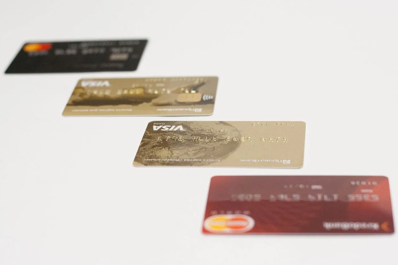 Four credit cards arranged on a white background, showcasing different designs and brands.